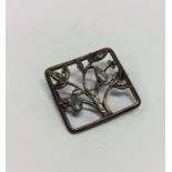 An Arts & Crafts rectangular brooch mounted with o
