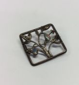 An Arts & Crafts rectangular brooch mounted with o