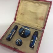 A boxed lacquer manicure set attractively decorate