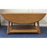 ERCOL: A good oval occasional table on spreading s