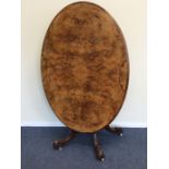 An attractive burr walnut tilt top table inlaid wi
