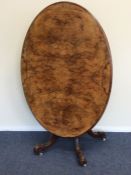 An attractive burr walnut tilt top table inlaid wi