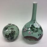 An unusual pair of Chinese green vases decorated w