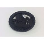 Bog Oak: A small oval brooch depicting a carved ch