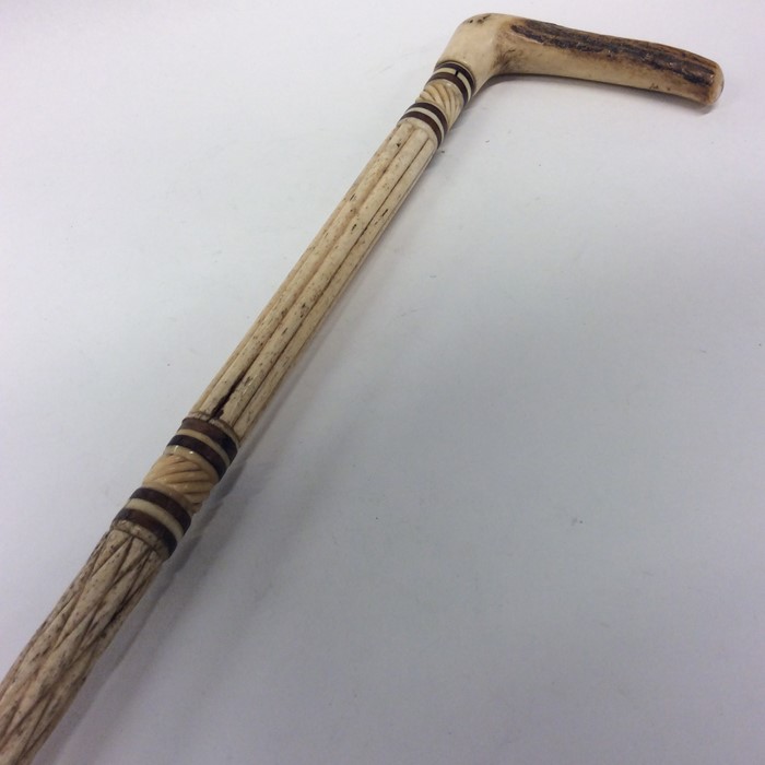 An Antique carved ivory walking stick with reeded
