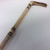 An Antique carved ivory walking stick with reeded