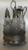 A good Georgian silver five bottle cruet on ball a