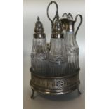 A good Georgian silver five bottle cruet on ball a