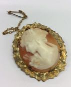 An oval cameo of a lady's head in gold frame. Appr
