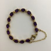 A heavy amethyst and gold bracelet with ring clasp