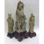 Three large heavy soapstone figures on carved base