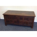 A good oak hinged top coffer in the style of Heals