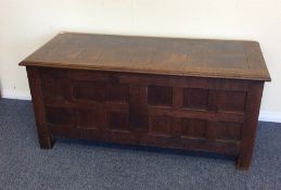 A good oak hinged top coffer in the style of Heals