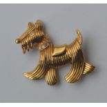 A high carat French brooch in the form of a dog wi