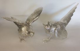 A good pair of cast silver models of pheasants wit