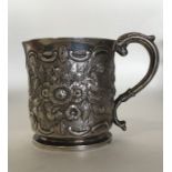 An embossed silver half pint mug attractively deco