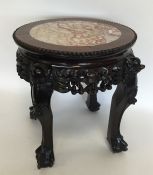 A small Chinese mahogany jardiniere stand with mar