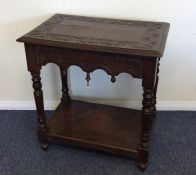 An oak carved side table with turned legs. Est. £2