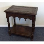 An oak carved side table with turned legs. Est. £2