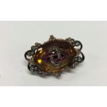 An Antique ruby, topaz and diamond oval brooch, th