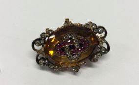 An Antique ruby, topaz and diamond oval brooch, th