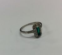 An Art Deco emerald and diamond step cut cluster r