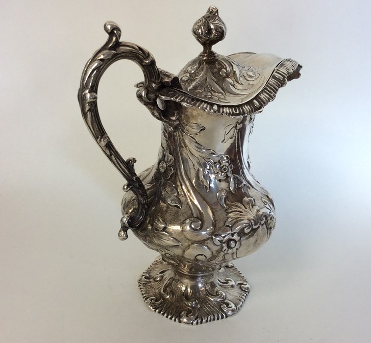 A Victorian silver embossed jug with hinged cover - Image 2 of 2
