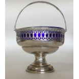 An attractive silver swing handled sugar basket on