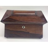 A rectangular rosewood tea caddy on ball feet with