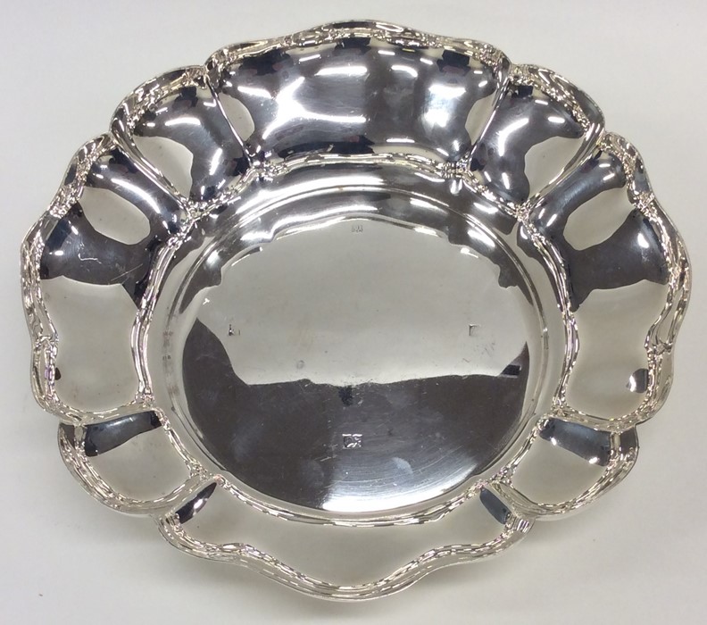 A heavy silver strawberry dish with wavy edge. Bir