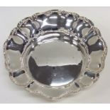 A heavy silver strawberry dish with wavy edge. Bir