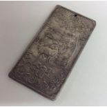 A large heavy silver Chinese ingot with floral dec