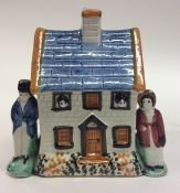 A Yorkshire Prattware moneybox cottage modelled wit