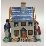 A Yorkshire Prattware moneybox cottage modelled wit
