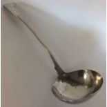 EXETER: A large fiddle pattern silver soup ladle.