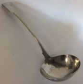 EXETER: A large fiddle pattern silver soup ladle.