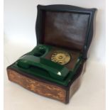 An unusual burr walnut box containing a telephone.