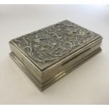 An Indian silver cigarette box embossed with figur