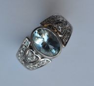 A heavy aquamarine and diamond ring in platinum ru