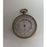 A small brass pocket barometer with silvered dial