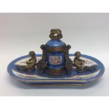 An attractive porcelain and brass mounted inkwell