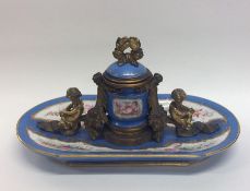 An attractive porcelain and brass mounted inkwell