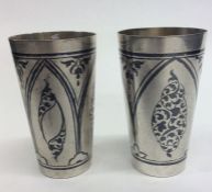 A pair of Russian niello and silver spirit tots wi