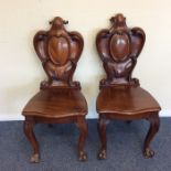 A pair of good large mahogany hall chairs with scr