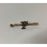 An unusual gold and diamond brooch in the form of