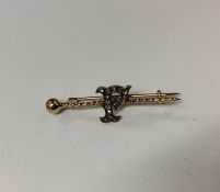An unusual gold and diamond brooch in the form of