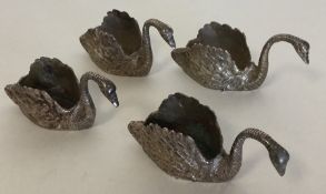 A heavy set of four cast silver swans with texture