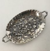 A Continental oval pin dish embossed with flowers