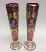 A pair of attractive cranberry and gilded flower v
