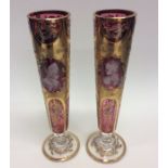 A pair of attractive cranberry and gilded flower v